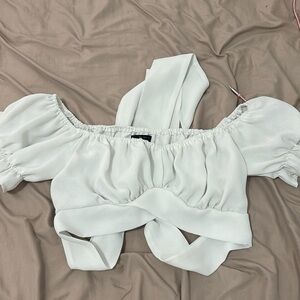 White crop top off the shoulders with a tie bow on the back